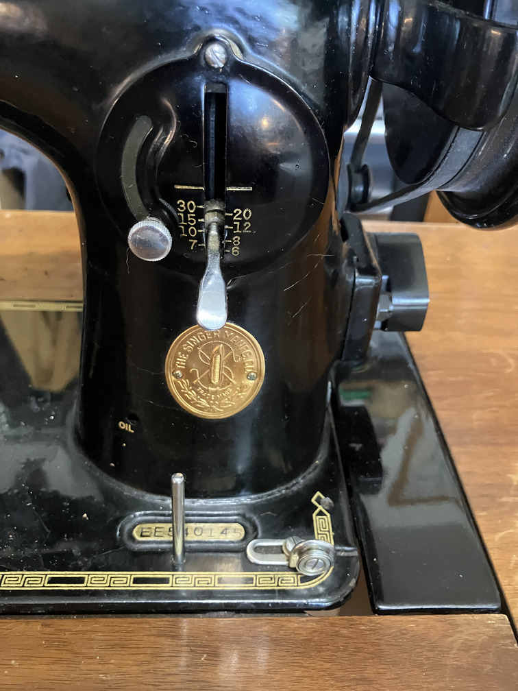 Tension dial, stitch regulator and badge